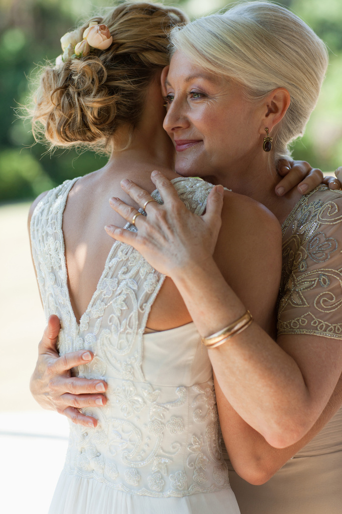 Mother hugging bride